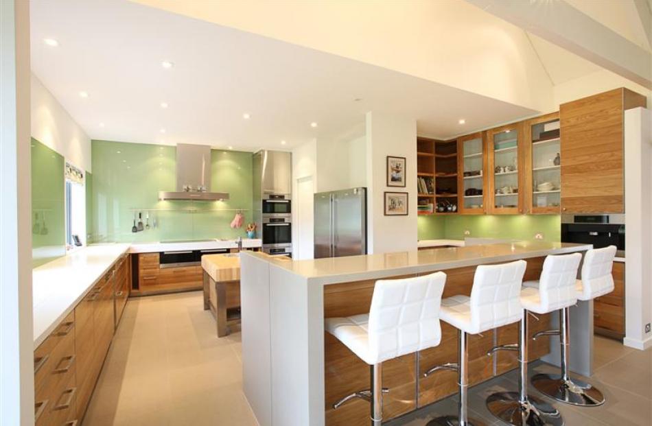 The glass splash-back in the kitchen injects colour into the otherwise neutral interior.