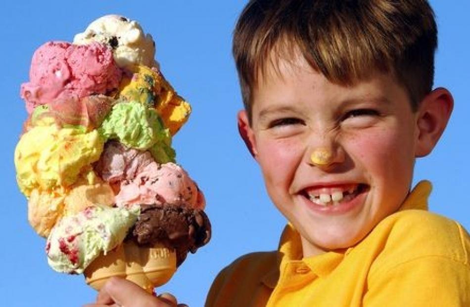 An impossibly large 10-scoop ice-cream is held by an obviously delighted Joseph Cathro (7). PHOTO...