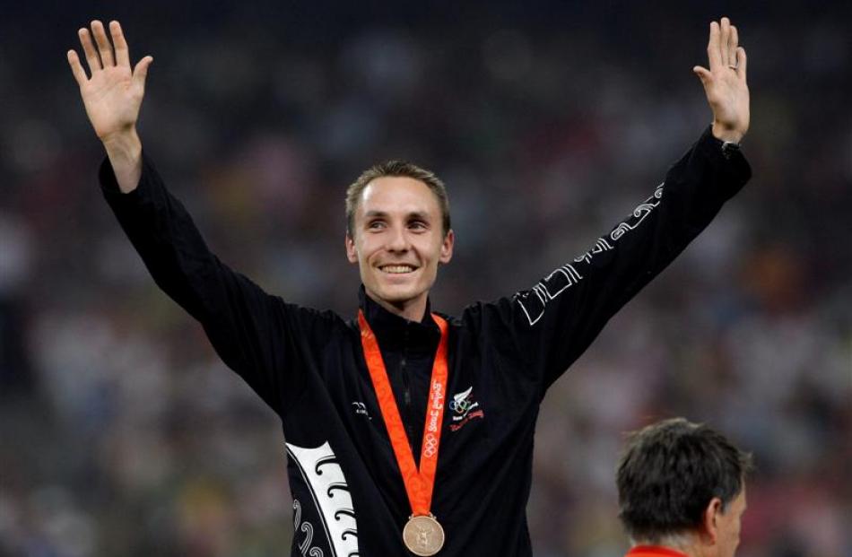 Men's 1500m bronze medalist Nick Willis of New Zealand waves with his medal during the awarding...