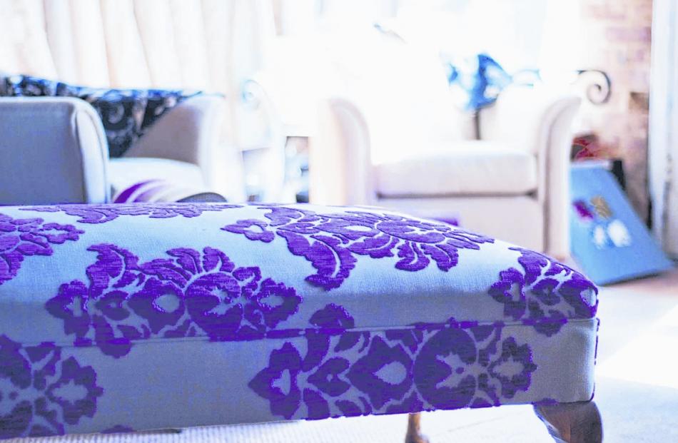 An ottoman covered in patterned fabric. Designed by Robyn Buis.