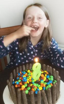 Sara Dawson, of Timaru, gets ready to blow out her candle and enjoy her cake as she turns 8...