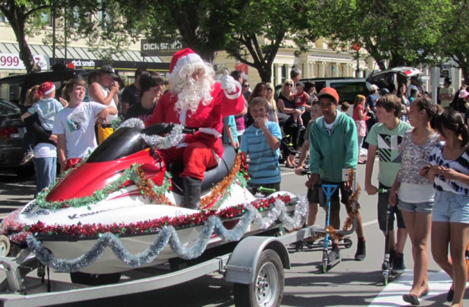 Santa, with a jet ski for a sleigh, at the OAmaru Santa Parade on Saturday. Photo by Ben Guild.