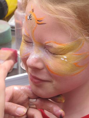 Emily Foster (7), of Timaru gets the finishing touches put on her swan face paint on Saturday....