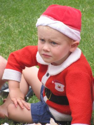 Jamie Baker (2), of Arrowtown, takes in the action at the Arrowtown Christmas Family Fun Day on...
