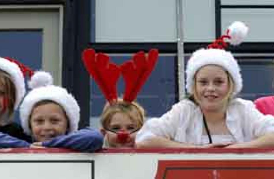 Getting a top view of the parade from The Loft balcony are (from left) Ella Monkhouse (8),...