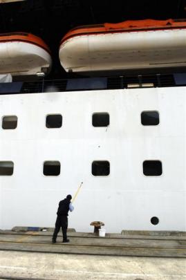 A crew member cleans the outside of the vessel.