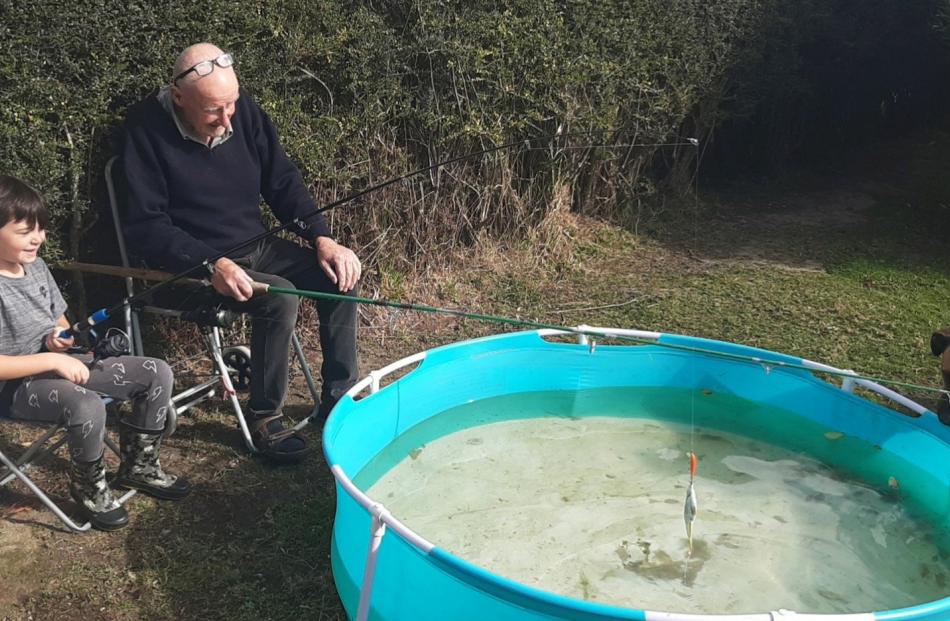 Any luck? "Fishing" in the backyard are Kingston Boyes (6) and his Grandad Tony Webb. PHOTO:...