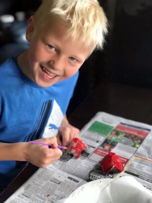 Creative endeavour . . . Max Smith (7) makes and paints poppies from egg cartons at home in...