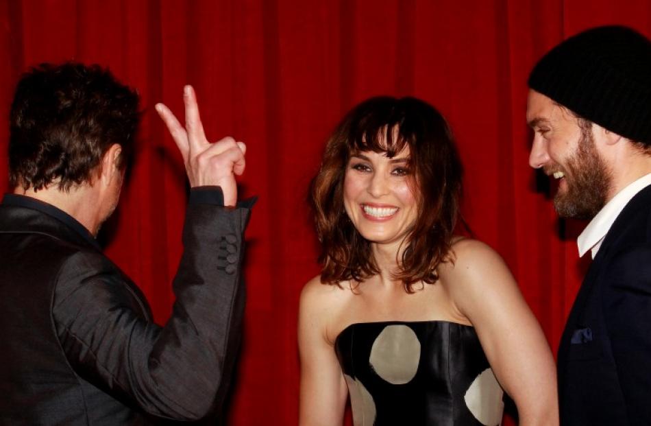 Actors Robert Downey Jr. (L), Noomi Rapace (C) and Jude Law pose for photographers at the...