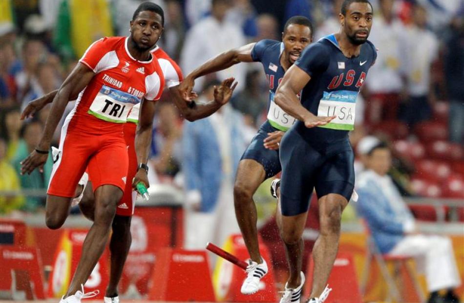 United States' Darvis Patton, 2nd right, and Tyson Gay, right, drop the baton in the men's 4x100...