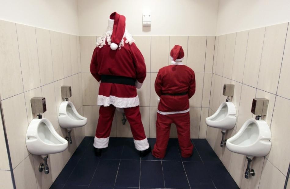 Two men dressed as Santa use a toilet in Citta' Sant'Angelo near Pescara, Italy. REUTERS...