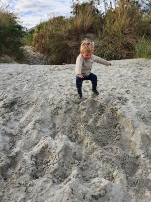 Leo Henderson (3) jumps in the sand at Ocean View Beach during a walk to get some fresh air...