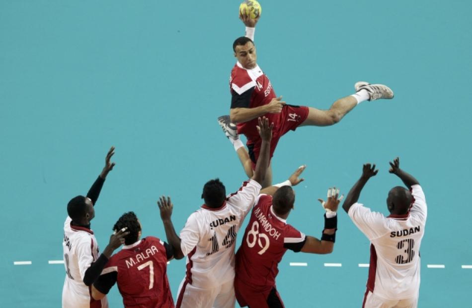 Egypt's Mohamed Elbohy (top) tries to score against Sudan during their men's handball game at the...