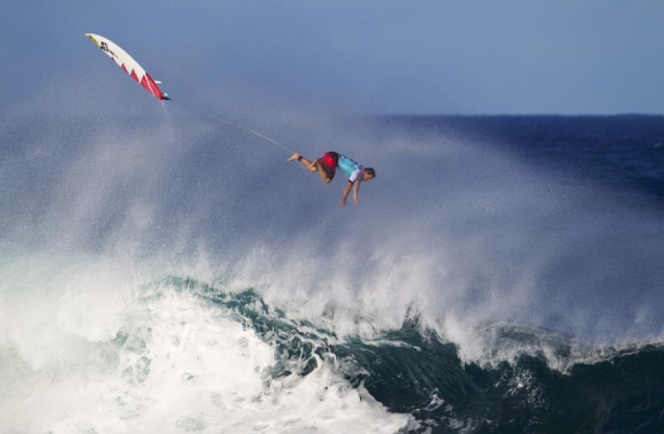 Kalani Chapman of Hawaii flies through the air as he exits a wave while competing during the...