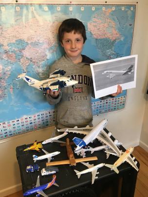 Sam Reeve (7), of Dunedin, with some of his planes and a picture of a LATAM plane. PHOTO:...