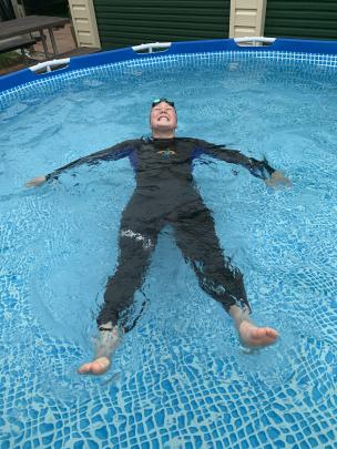 Swimmer Madi Wills (16) is still smiling as she braves her pool (12degC) after missing out on...