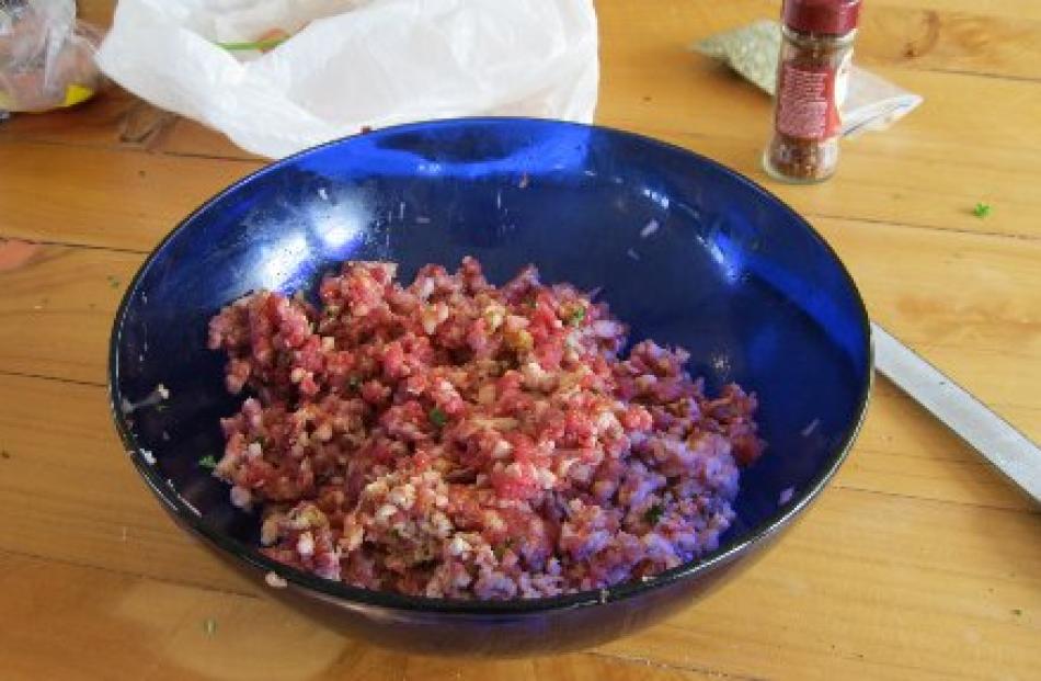 Spices and flavourings are mixed with the ground meat.