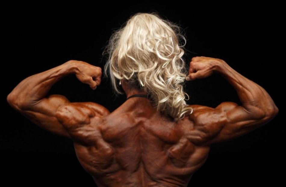 A contestant competes in the Amateur Women's Classic Bodybuilding competition at the FIBO 2011 in...
