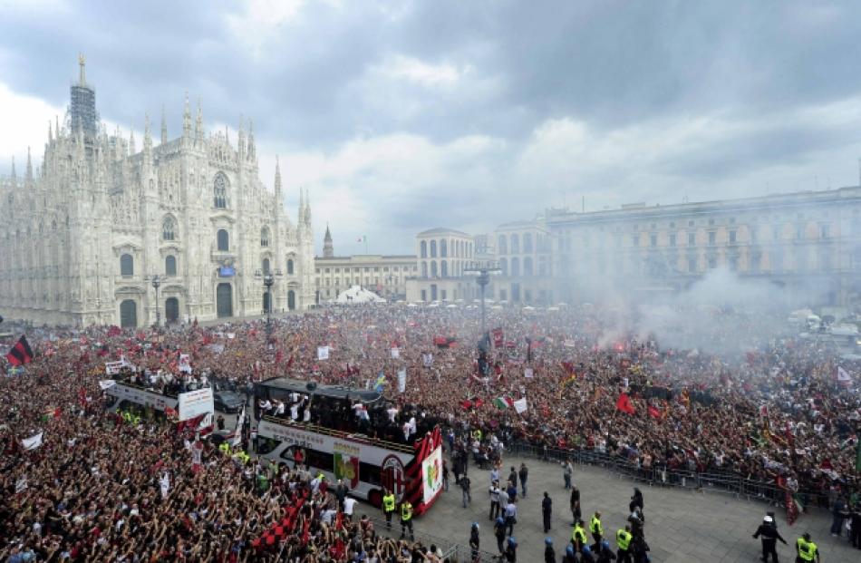 AC Milan's players and staff celebrate on a bus, after the team won their 18th Serie A title, in...