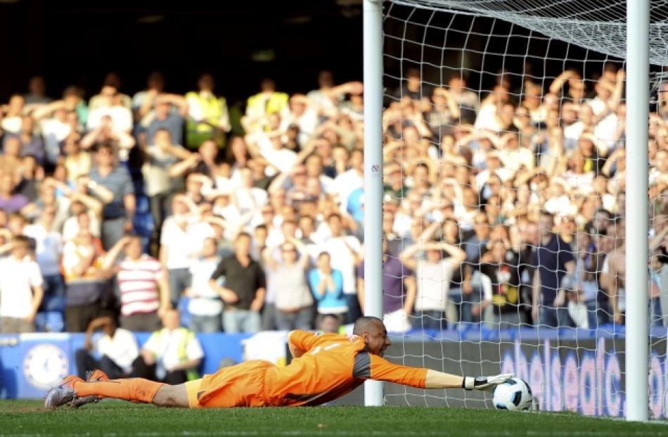 Tottenham Hotspur's goalkeeper Heurelho Gomes tries to stop a shot from Chelsea's Frank Lampard...