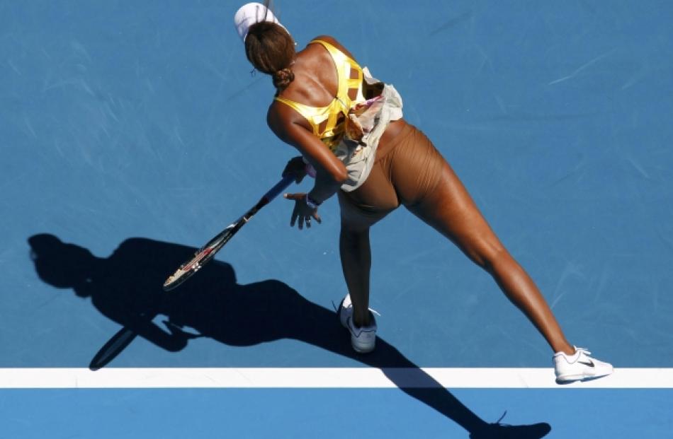 Venus Williams of the US serves to Sandra Zahlavova of the Czech Republic during their match at...