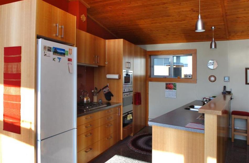 The kitchen features a gas hob and a German-made low-energy refrigerator.