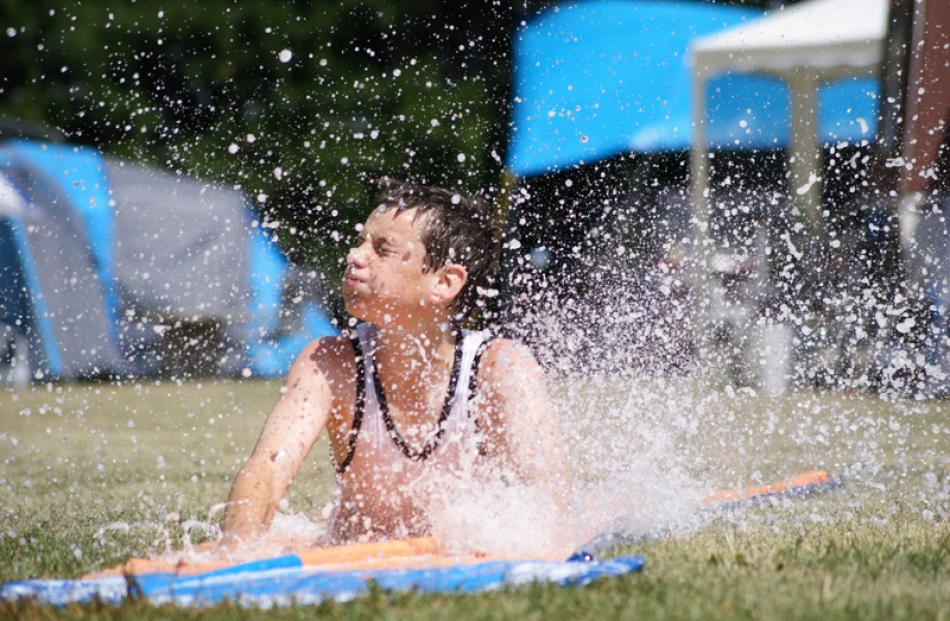 The waterslide at Ranfurly Holiday Park takes a bashing from Aaron Tarleton (12), of Dunedin....
