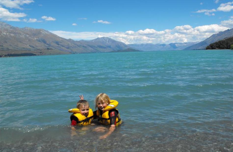 Lucy (8) and Sam Glover (5) sit at the head of Lake Wakatipu in Kinloch just before Christmas.