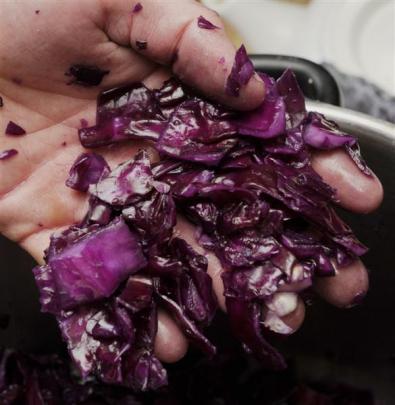 Rory Harding makes good use of the lush garden at his Dunedin home and, below, ferments cabbage....