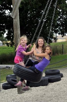 Having fun on a tyre swing are (from left) Lily Templeton (6), Zoe Clarke (11) and Tearamai...