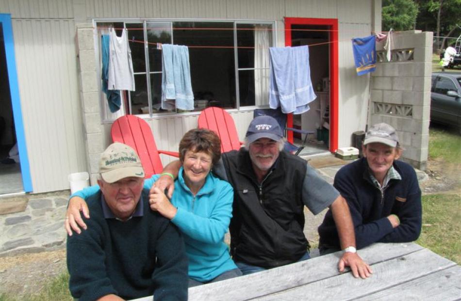 People watching while waiting for the wind to drop are from left, Robert and Lori Rusbatch, both...