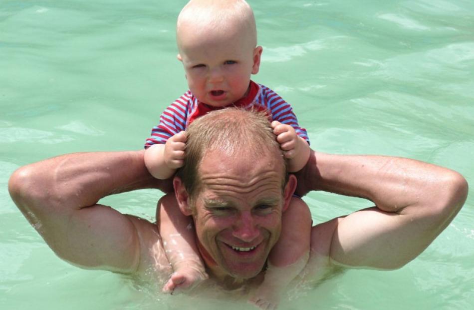 Father and son Tony and Sam (9 months) Kearney, of Shingly Creek, Ranfurly, enjoy a dip in the...