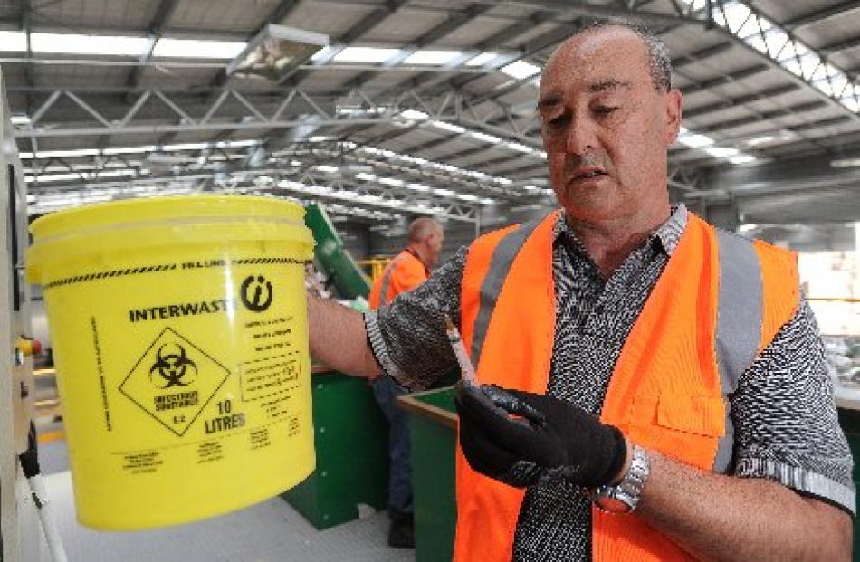 Fullcircle Recycling territory manager Taane Royce examines one of many syringes found by staff...