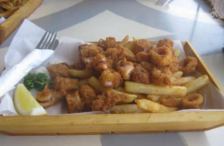 Enjoying calamari and chips by the beach.