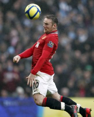 Manchester United's Wayne Rooney heads to score his second goal against Manchester City during...