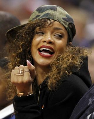 Rihanna sits courtside during the NBA basketball game between the Los Angeles Clippers and the...