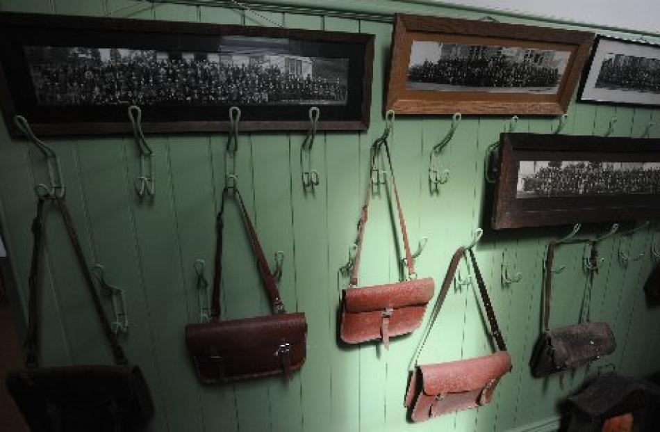 Schoolbags and photographs hang in the former Outram School.