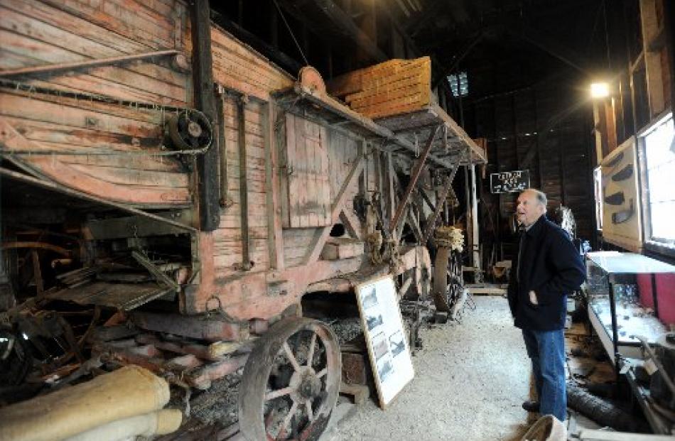 Taieri Historical Society president Neil Gamble admires the last threshing mill to be used on the...