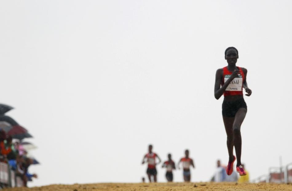 Linet Masai (R) of Kenya competes at the Italica cross-country race in Santiponce, near Seville...