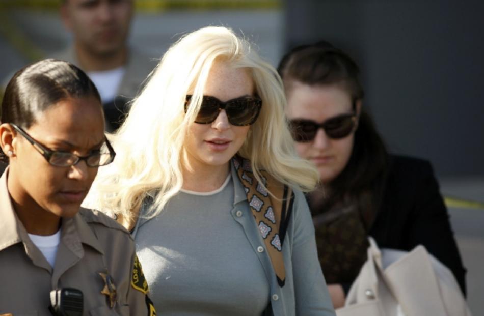 Actress Lindsay Lohan leaves the court after a progress report hearing in Los Angeles, examining...