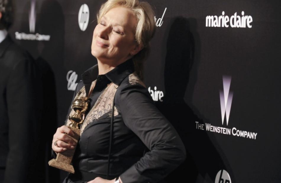 Meryl Streep shows off her Best Actress Golden Globe during her arrival at the The Weinstein...