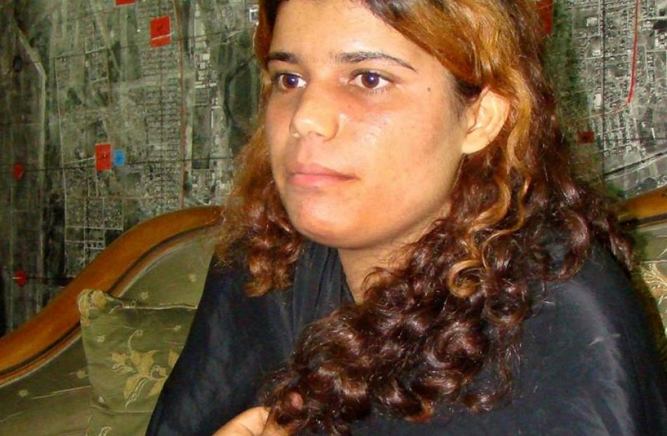 In this photo released by the Iraqi Police, a girl who they suspected of being a suicide bomber...