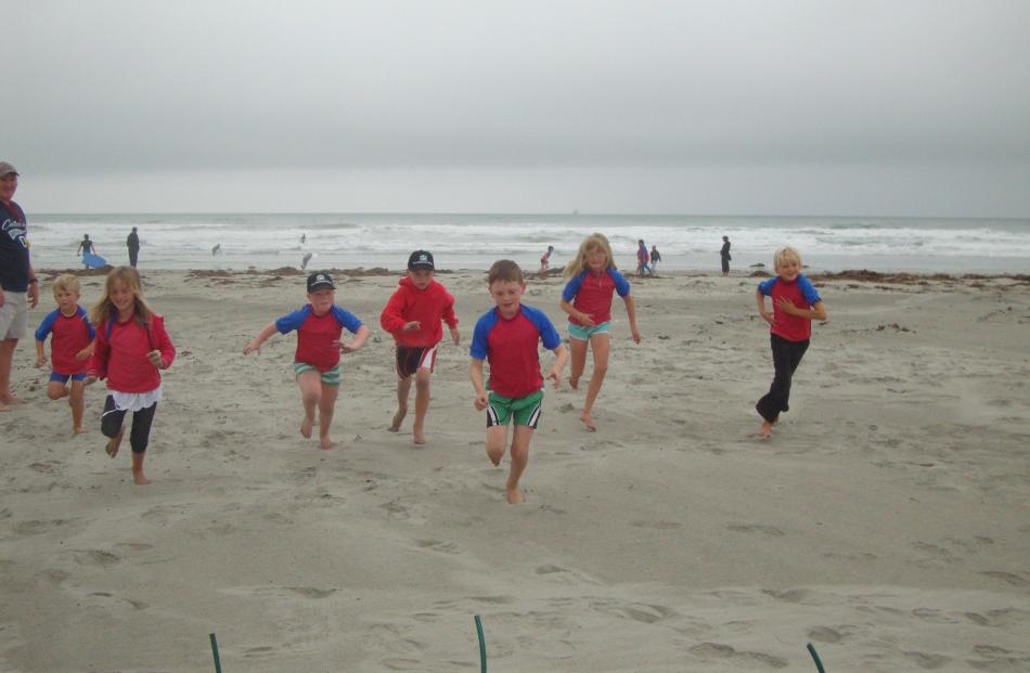 Under-8s in a 'beach flags' race (from left) Roland Ozanne, Tessa Muldrew, Madison Lobb, Mitchell...