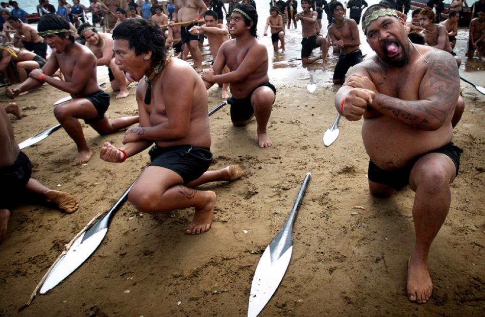 Waka crew perform a haka. Photo by The New Zealand Herald.