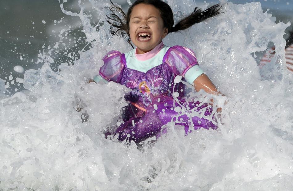 Jazz Fraser relishes the icy water during the Polar Plunge at St Clair Beach yesterday. PHOTOS:...
