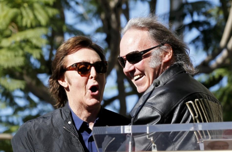 Paul McCartney (L) greets Neil Young before unveiling his star on the Walk of Fame in Hollywood....