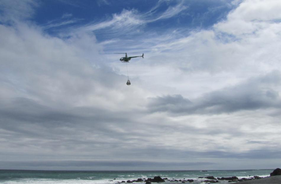 Greenstone Helicopters aircraft carries fadges of rubbish.