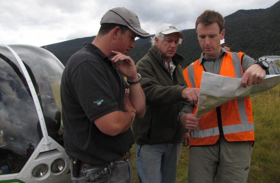 Pilots Peter Spencer-Bower and Geoff Robson discuss routes with Julian Tovey.