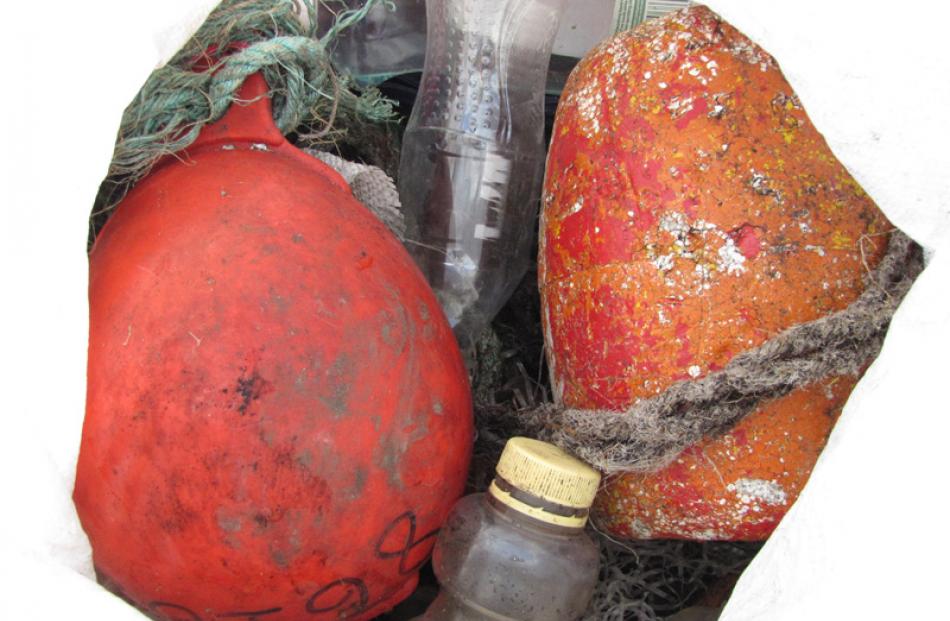 Plastic rubbish inside a fadge includes bright orange fishing floats.