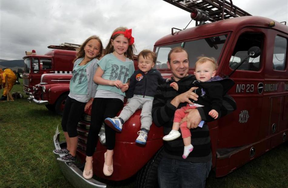 Resting on  an old Dunedin Metropolitan Fire Service appliance yesterday  are (from left) Mia...